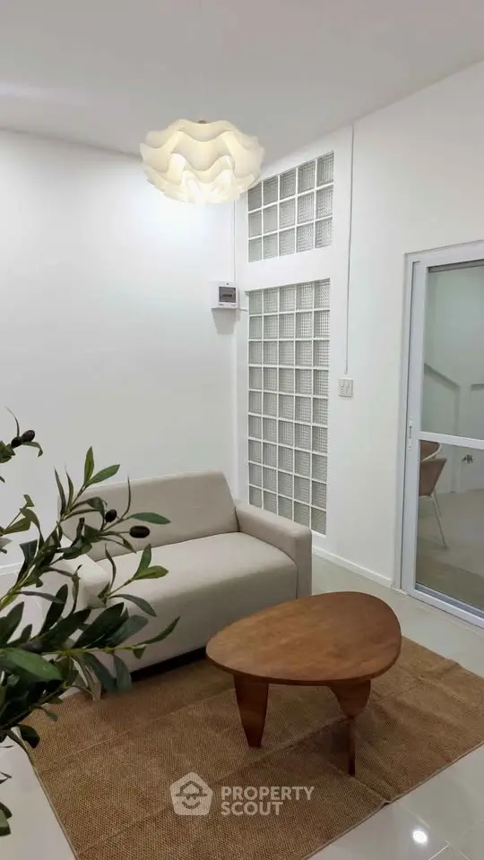 Modern living room with stylish furniture and unique lighting, perfect for cozy relaxation.
