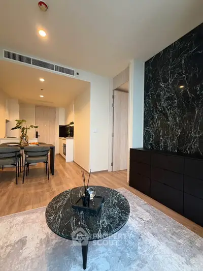 Modern living room with marble coffee table and open kitchen layout