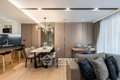 Modern open-plan living room with stylish dining area and sleek kitchen design.