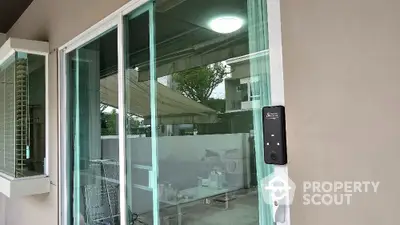 Modern sliding glass door with electronic lock in contemporary home exterior