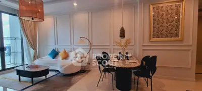 Elegant living room with modern decor and dining area, featuring stylish furniture and wall art.
