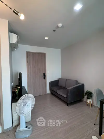 Modern living room with cozy sofa and sleek wooden flooring