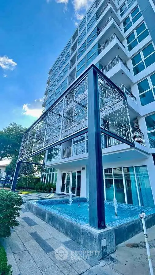 Modern building exterior with unique architectural design and water feature