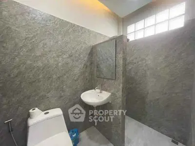 Modern bathroom with sleek gray tiles and natural light