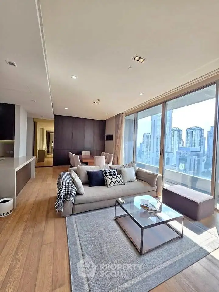 Luxurious living room with stunning city view and modern decor in high-rise apartment