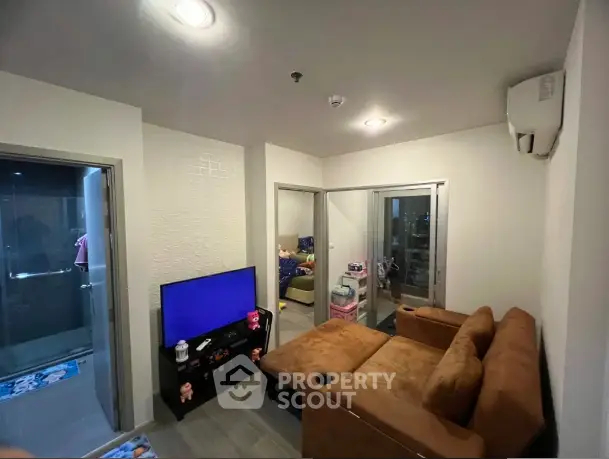 Cozy living room with brown sofa and modern decor in compact apartment