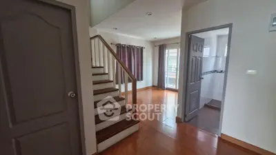 Spacious interior with wooden staircase and natural light