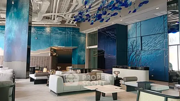Luxurious modern living room with ocean-themed decor and elegant furnishings.