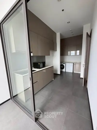 Modern kitchen with sleek cabinetry and integrated appliances in a contemporary apartment.