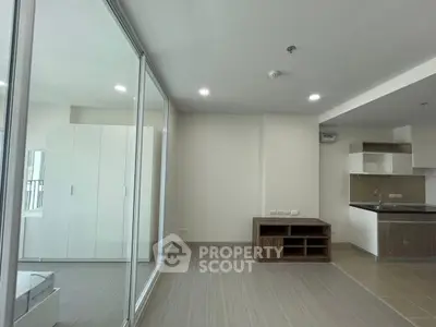 Modern open-plan living space with sleek kitchen and ample natural light.