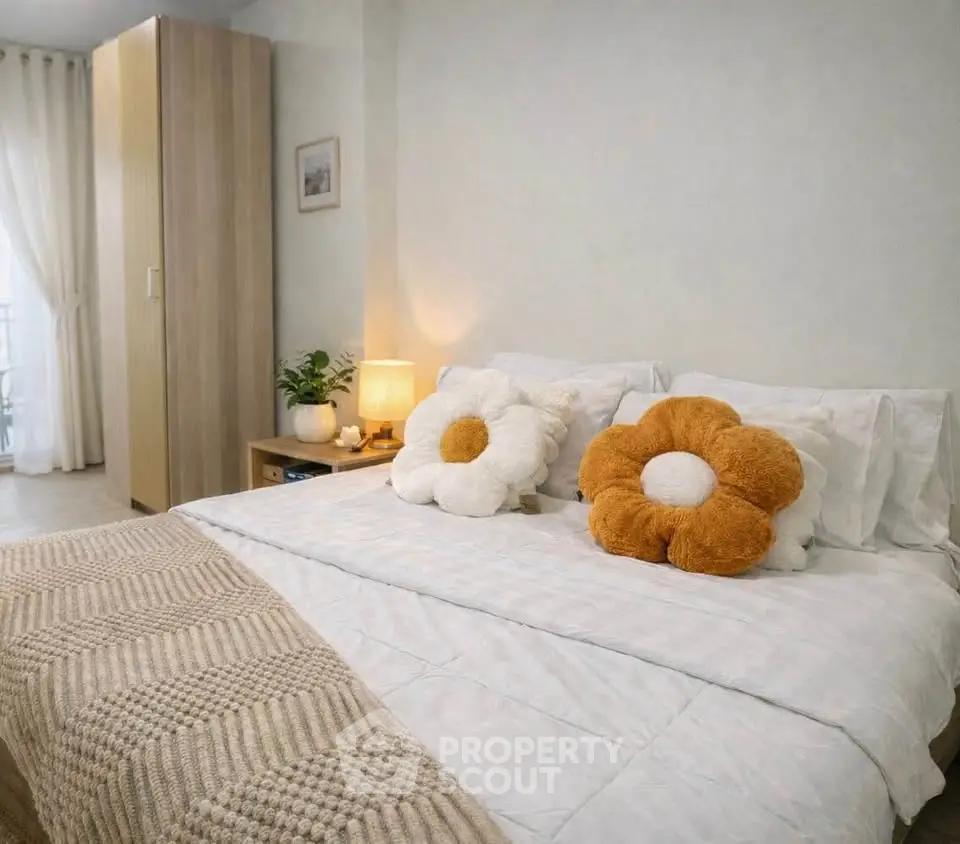 Cozy bedroom with stylish decor and plush flower pillows