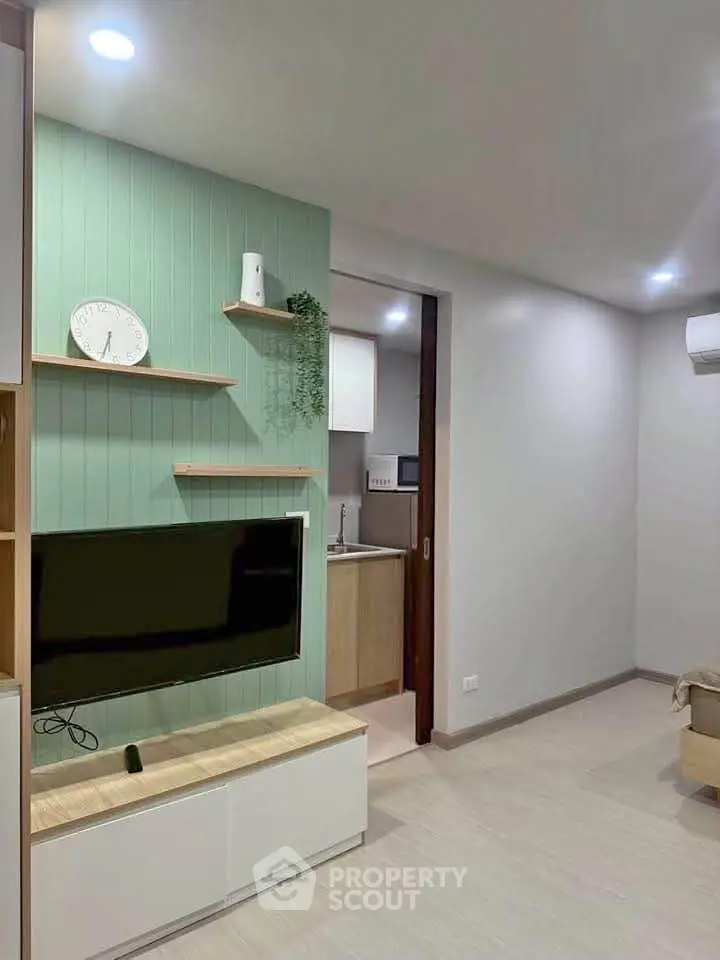 Modern living room with stylish TV unit and open kitchen view