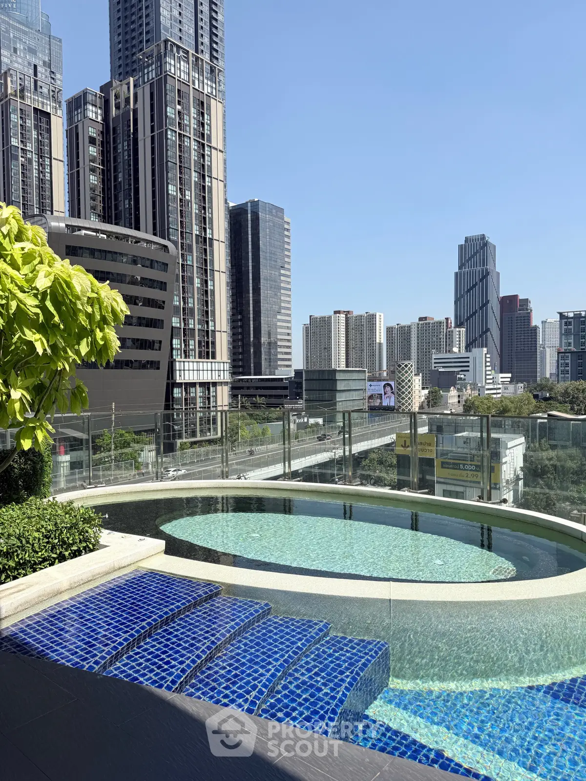 Luxurious rooftop pool with stunning city skyline views in modern urban setting.