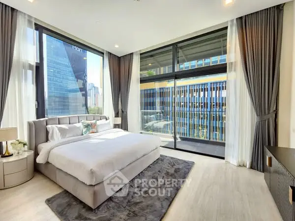 Luxurious bedroom with floor-to-ceiling windows and stunning city view