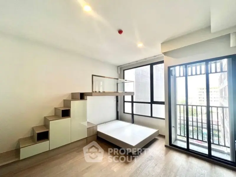 Modern minimalist living space with loft bed and large windows