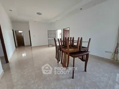 Spacious unfurnished living room with tiled floors and natural light
