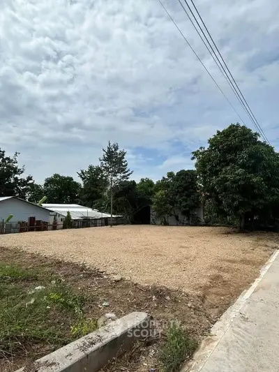 Spacious vacant land plot with lush greenery, perfect for development opportunities.