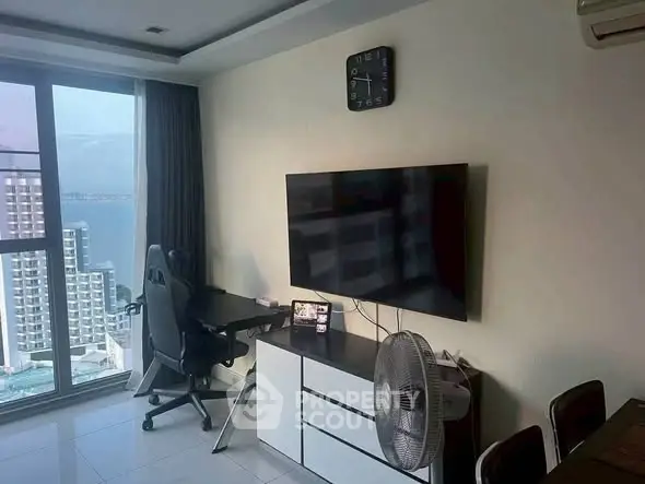 Modern living room with stunning ocean view and sleek furnishings.