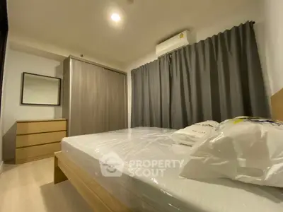 Cozy modern bedroom with air conditioning and stylish furnishings