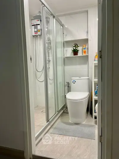 Modern bathroom with glass shower and sleek fixtures in a contemporary home.