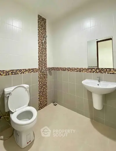 Modern bathroom with sleek design and mosaic tile accents