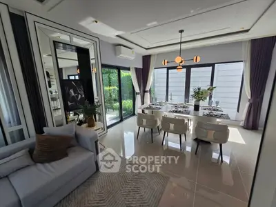 Luxurious modern living room with elegant dining area and garden view, featuring stylish decor and ample natural light.