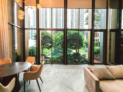Luxurious living room with floor-to-ceiling windows and stunning garden view in modern high-rise building.