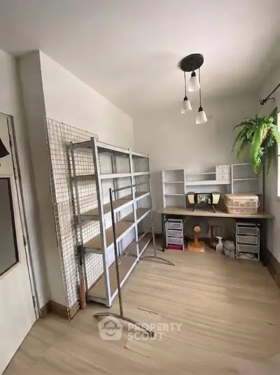 Spacious study room with modern shelving and natural light, perfect for productivity and organization.