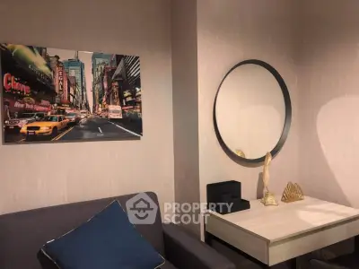 Stylish living room with modern decor and New York City artwork, featuring a cozy sofa and elegant mirror.