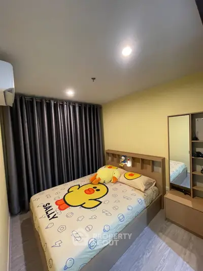 Cozy bedroom with playful duck-themed bedding and modern furnishings, perfect for a relaxing retreat.
