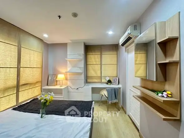 Modern bedroom with stylish decor, built-in shelves, and cozy lighting for a comfortable living experience.