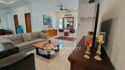 Spacious modern living room with elegant decor and ample natural light.