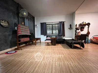 Spacious living room with wooden flooring and cozy seating area