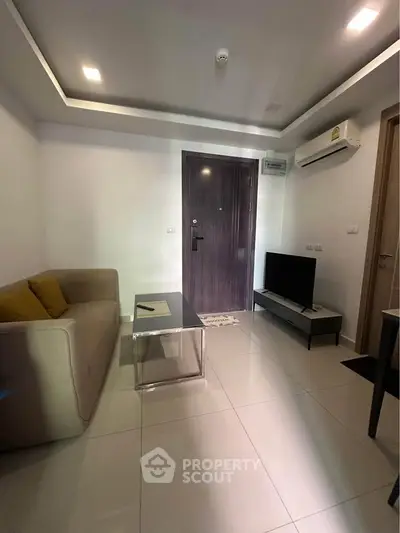 Modern living room with sleek furniture and air conditioning in a cozy apartment.