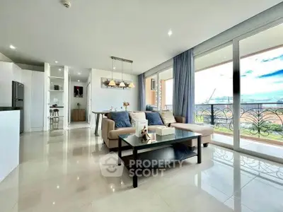 Spacious modern living room with large windows and elegant decor in a luxury apartment.