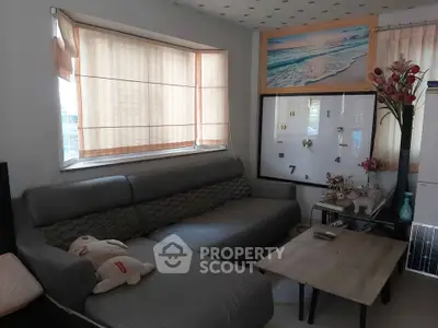 Cozy living room with modern gray sofa and stylish decor, perfect for relaxation.