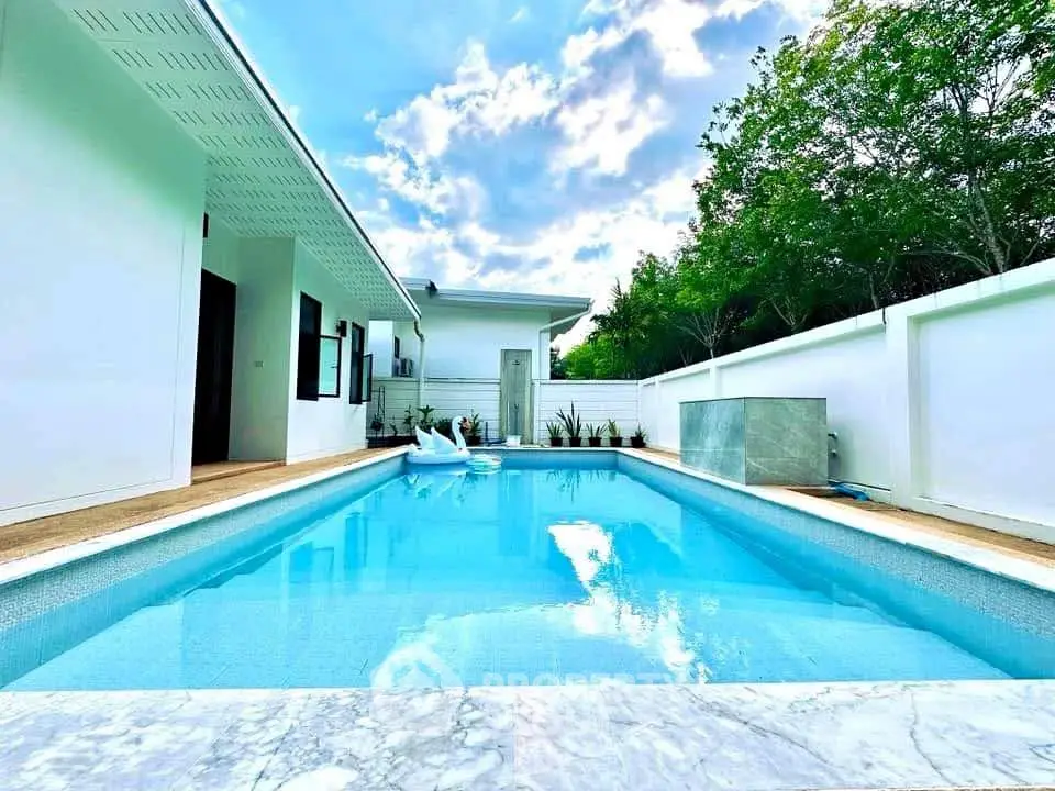 Luxurious modern home with stunning private pool and serene outdoor space.