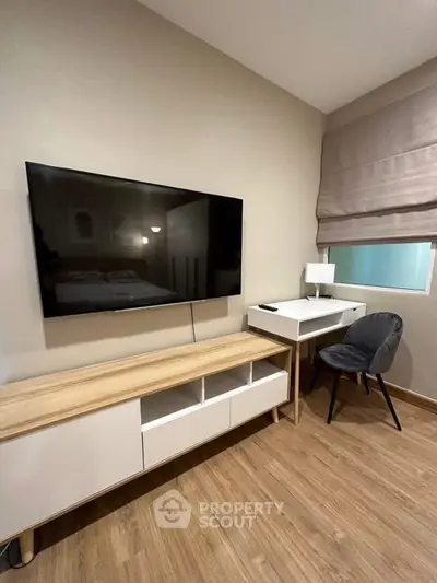Modern living room with wall-mounted TV and stylish furniture