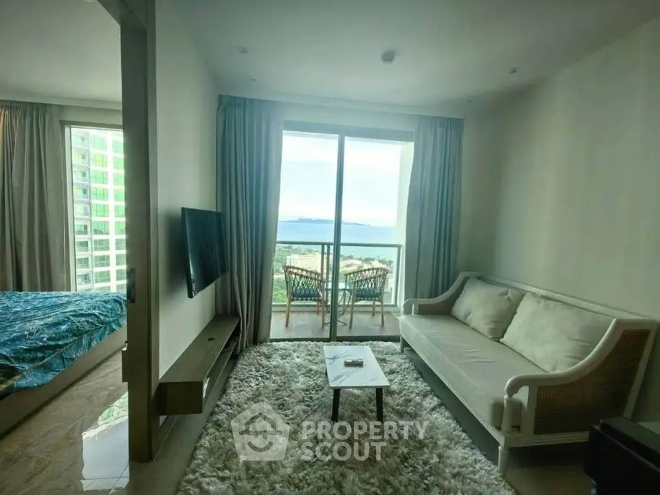 Modern living room with ocean view and cozy balcony in luxury apartment