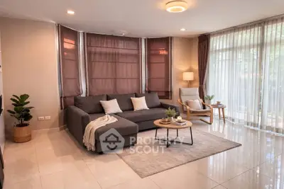 Spacious living room with modern furniture and large windows for natural light.