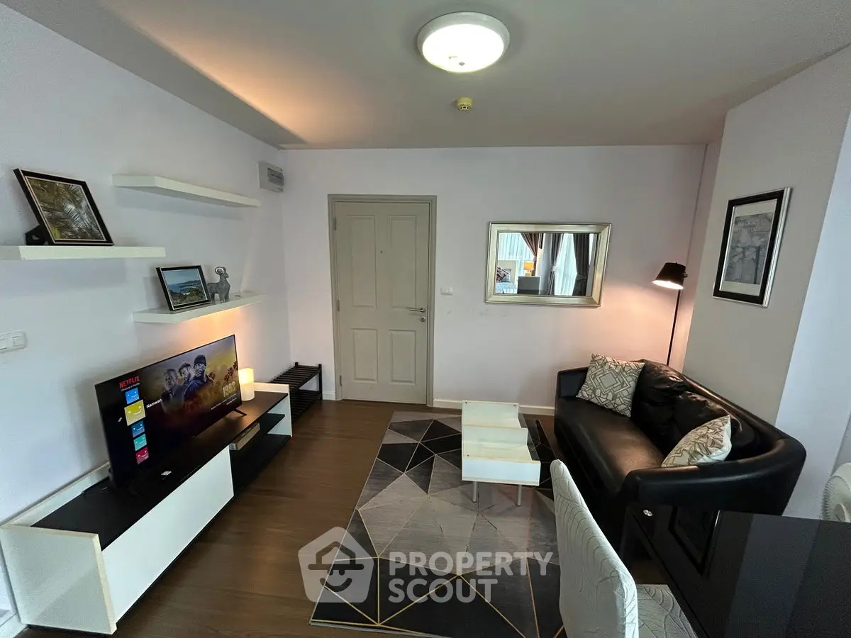 Modern living room with sleek black sofa and stylish decor