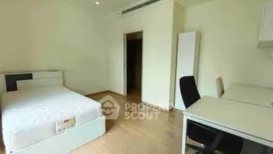 Spacious bedroom with modern furniture and wooden flooring