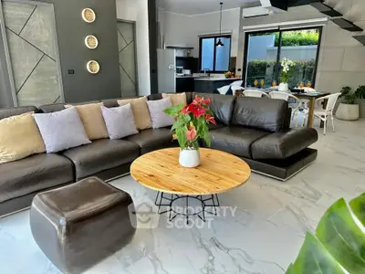 Modern open-plan living room with stylish decor and garden view, featuring a cozy seating area and dining space.