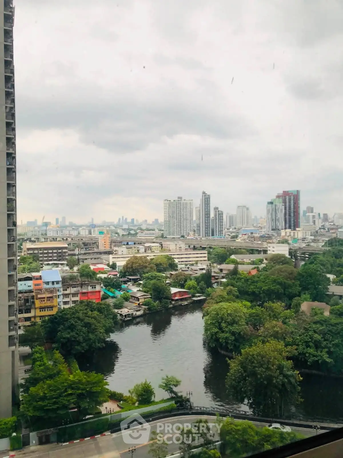 Stunning cityscape view from high-rise apartment overlooking river and skyline.