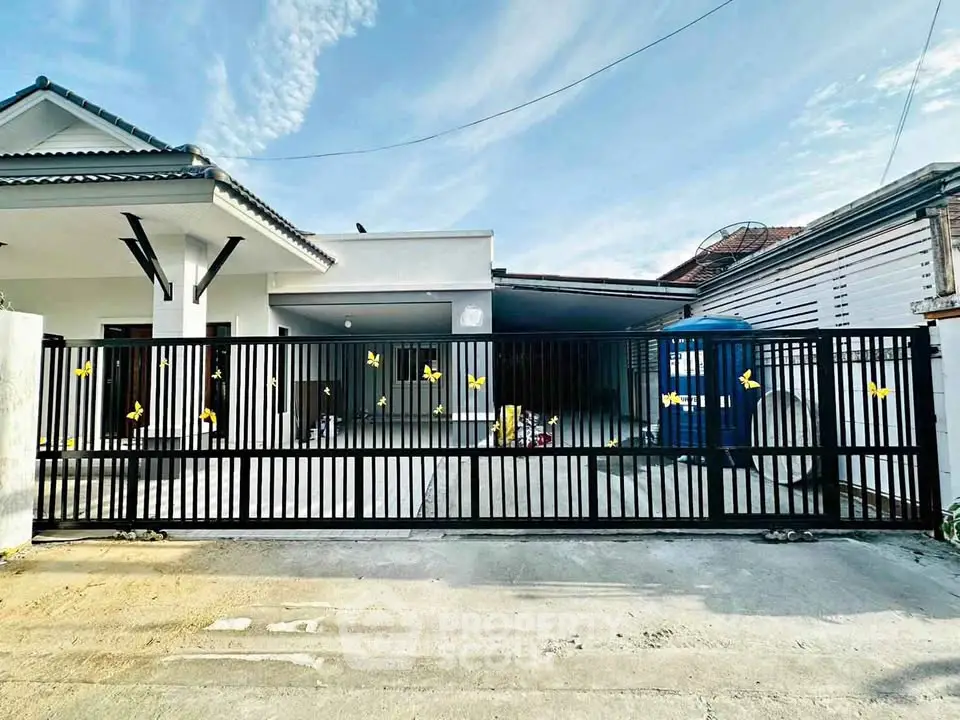 Charming single-story home with gated entrance and spacious driveway, perfect for family living.
