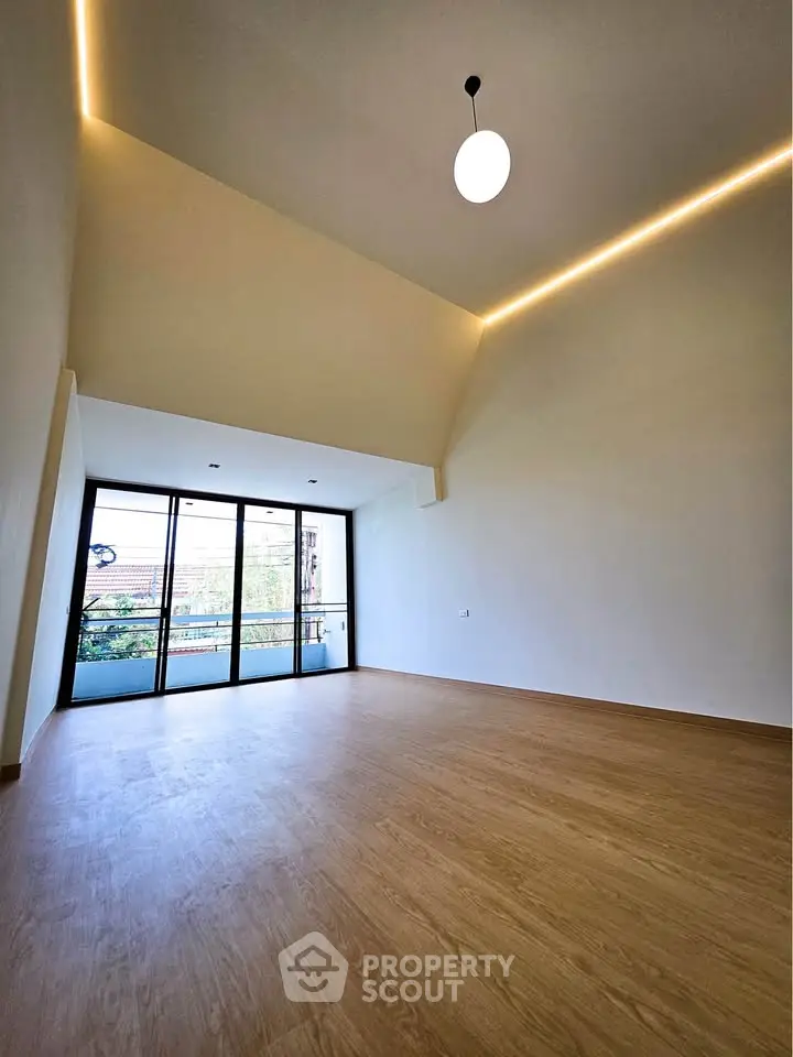 Spacious modern living room with high ceilings and large windows for natural light.