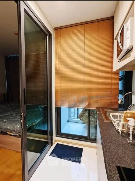 Compact kitchen with sliding glass door and modern appliances