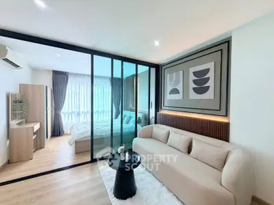 Modern living room with glass partition and cozy bedroom view