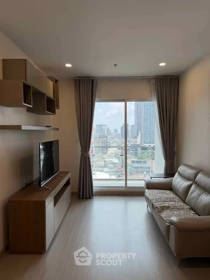 Modern living room with large window offering stunning city view, featuring sleek furniture and stylish decor.