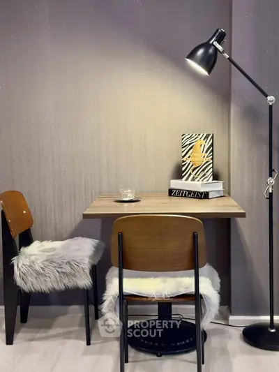 Cozy study nook with stylish chairs and modern lamp